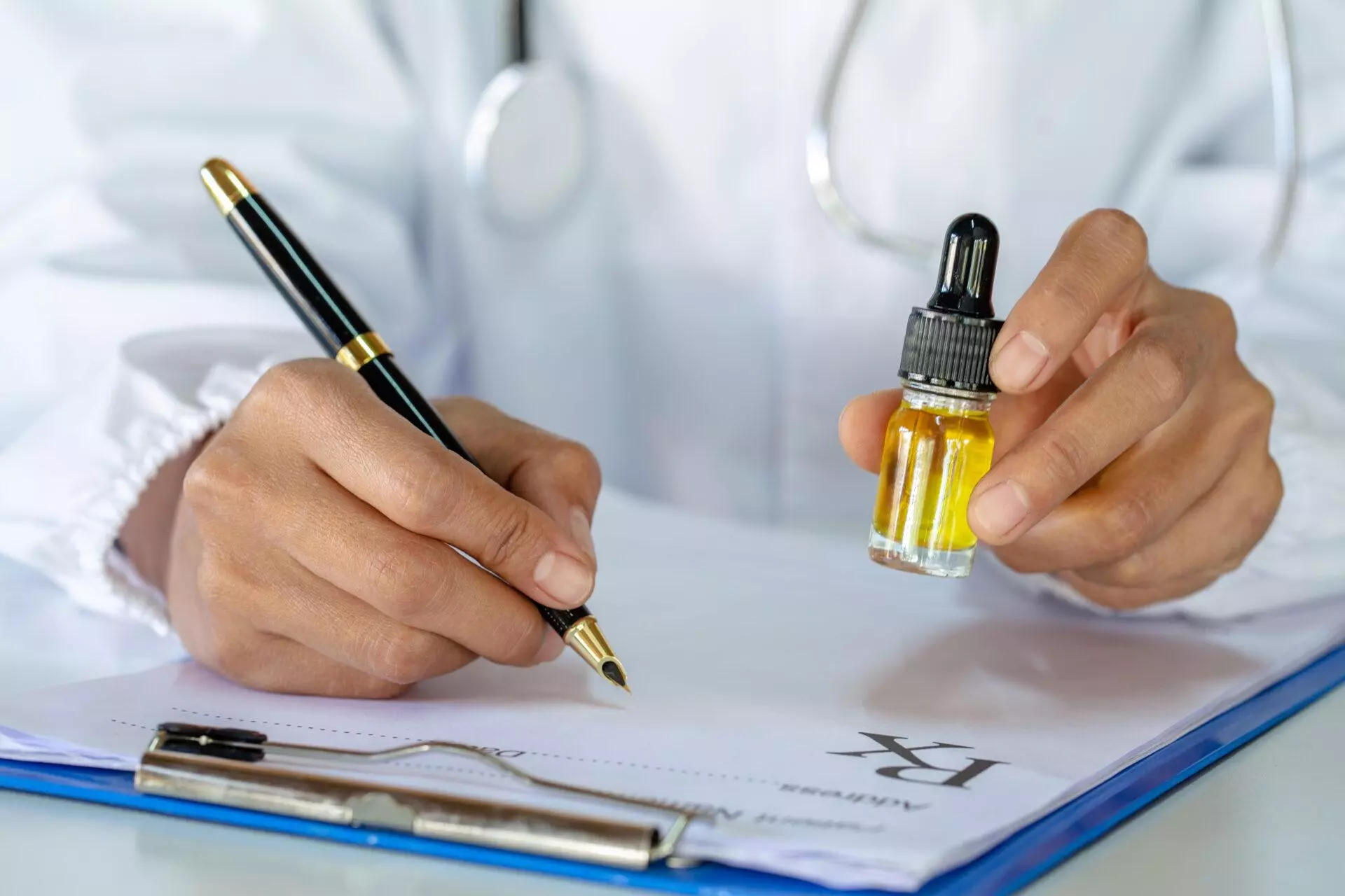 Doctor writing prescription and offering patient medical cannabis oil.