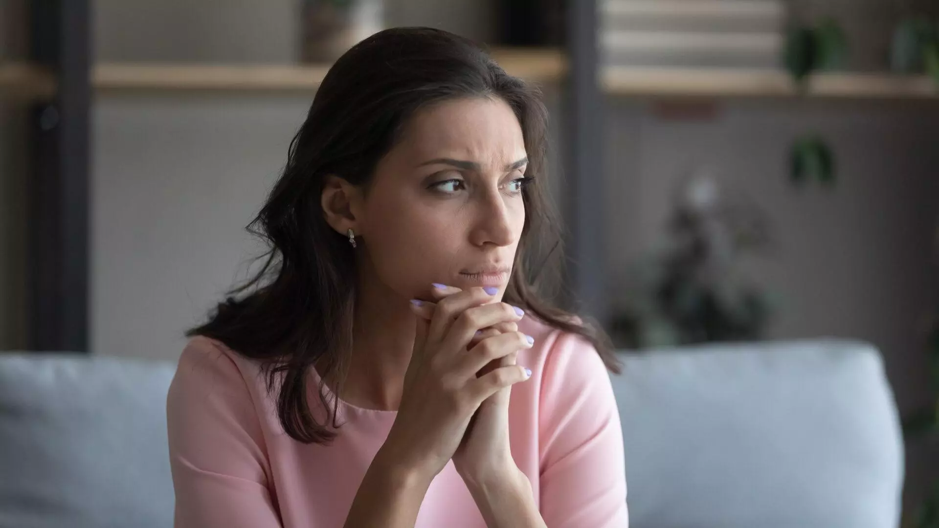 Anxious woman at home.