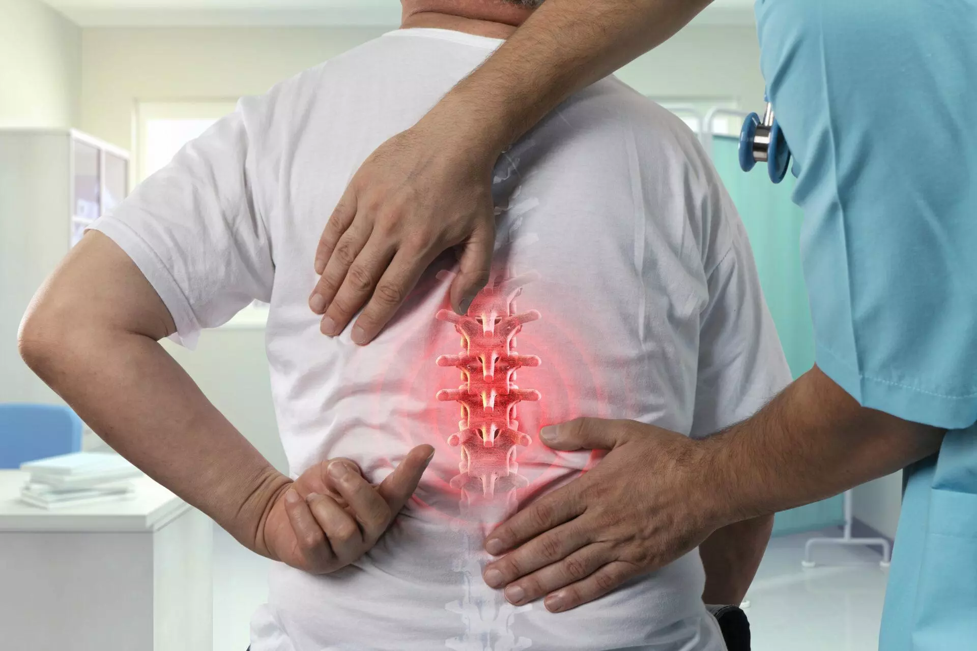 Doctor examining spine pain of an elderly male patient with a graphic of the spine in red