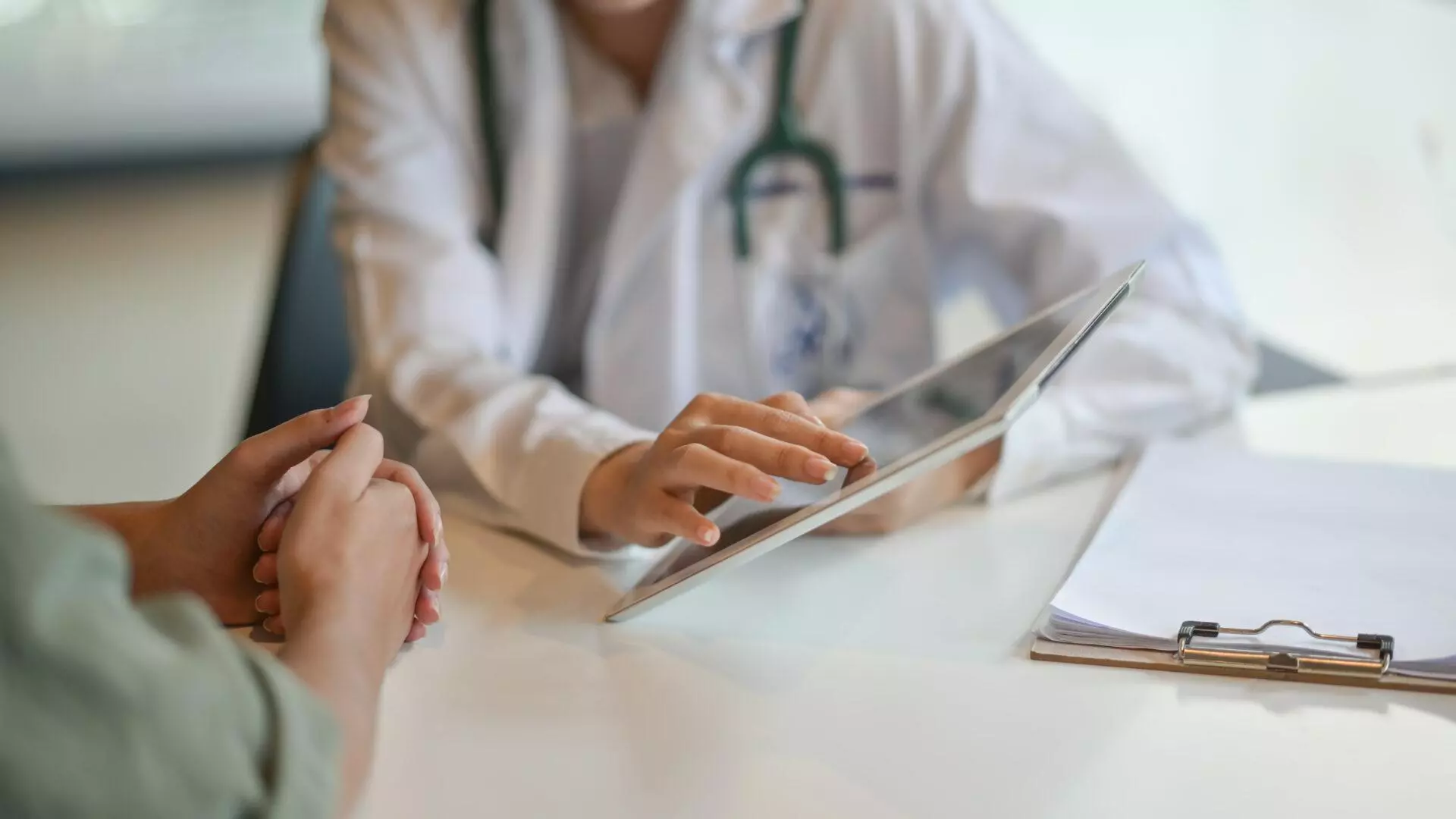 Shot of a doctor showing a patient some information on a digital tablet.