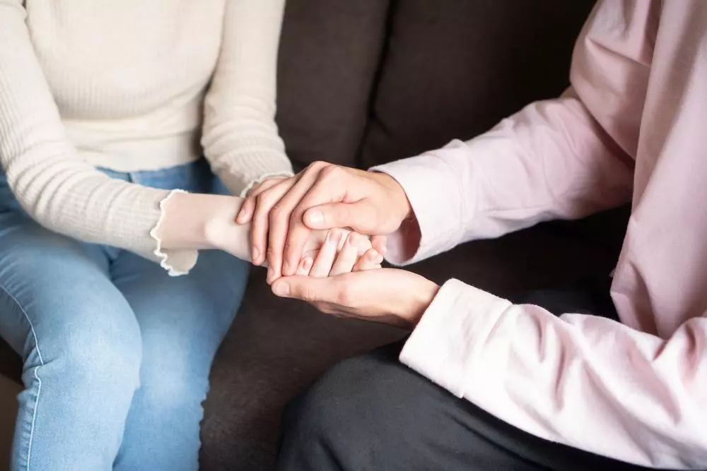 Close-up Man holding the hands of a woman