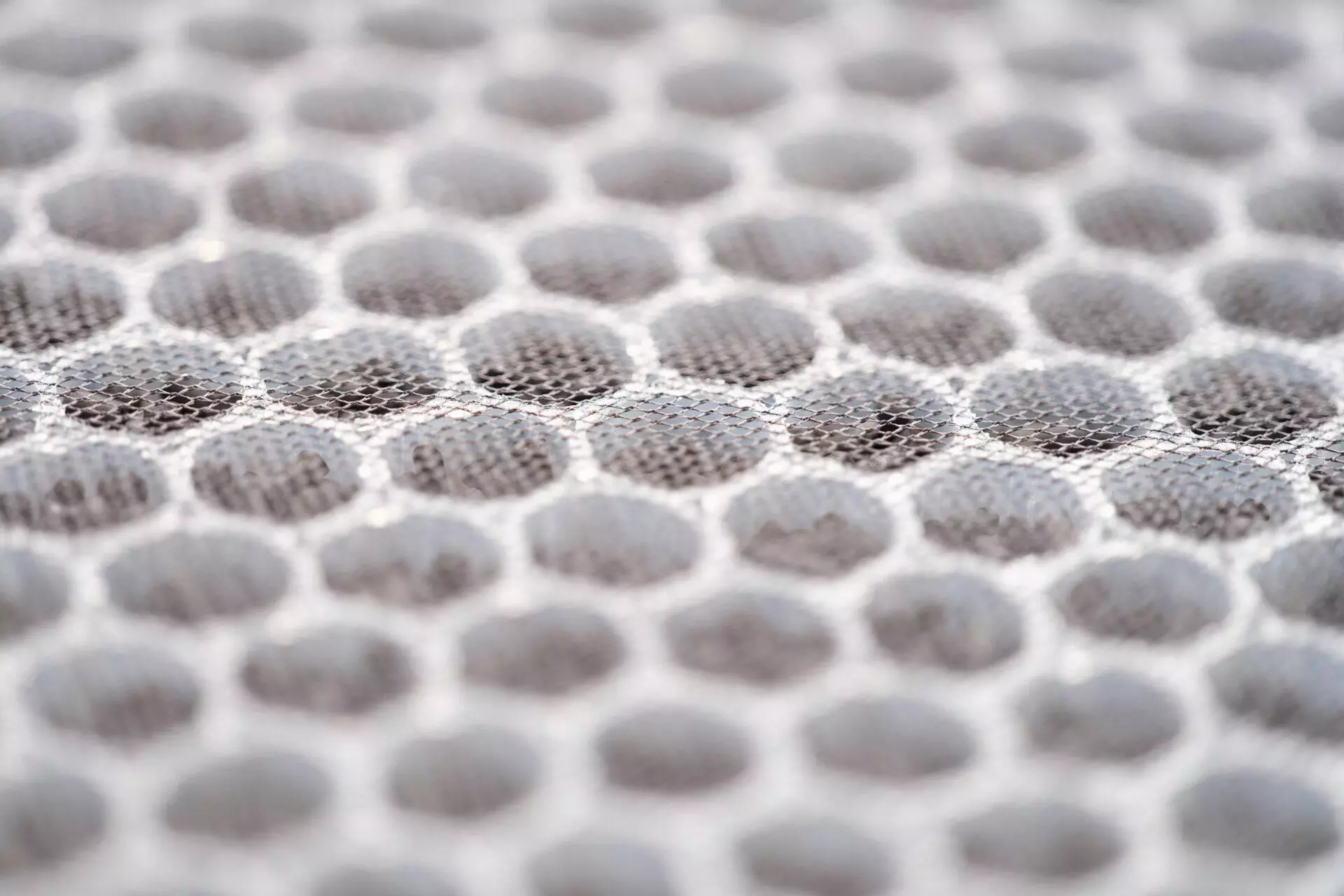 Close-up of a multi-stage air filter with UV radiation and activated carbon granules.