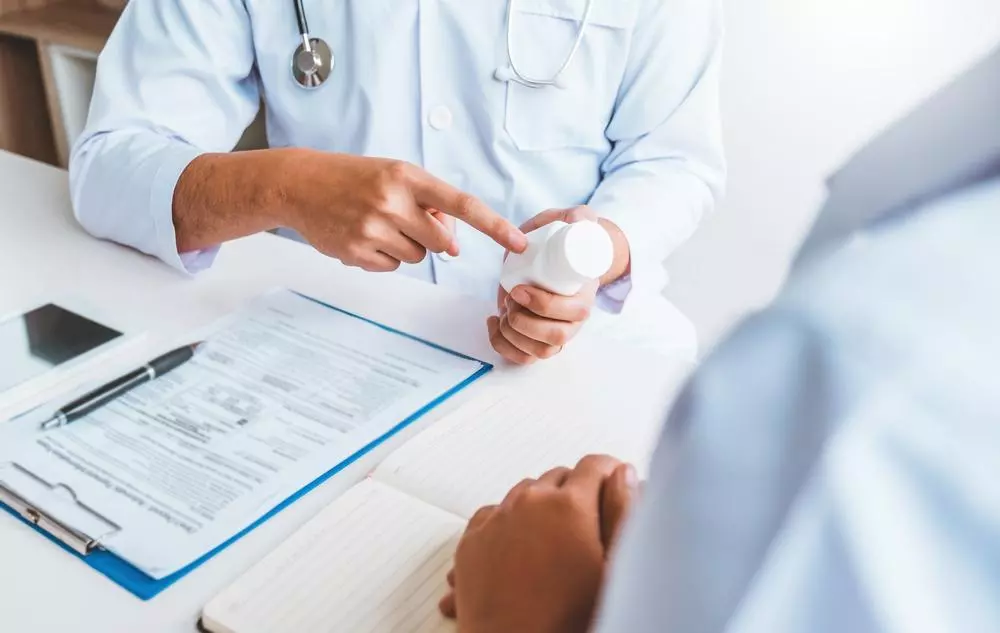 Doctors and patients consulting about treatment guidelines at office