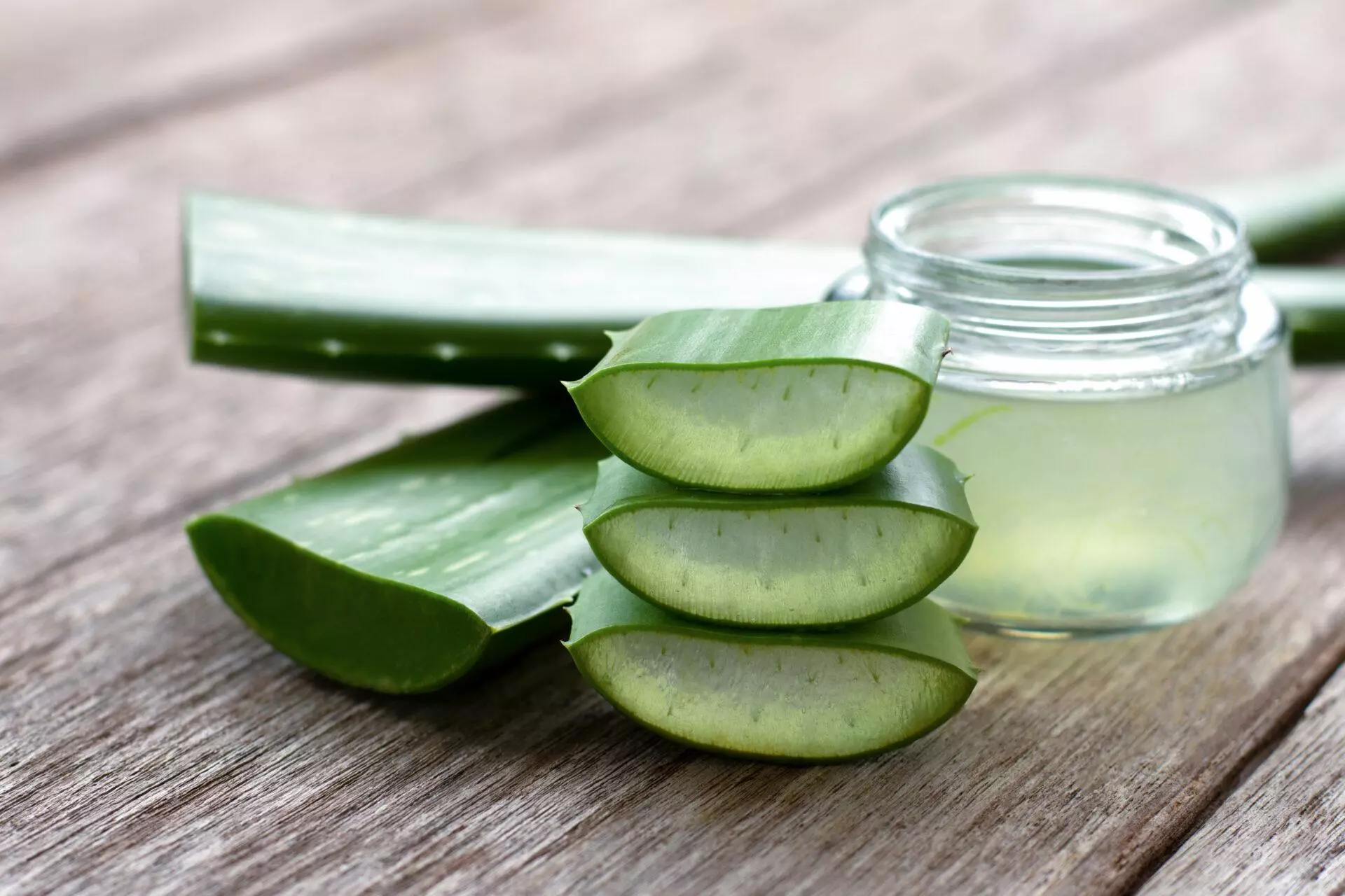 Aloe vera sliced and aloe vera gel on wood table background.
